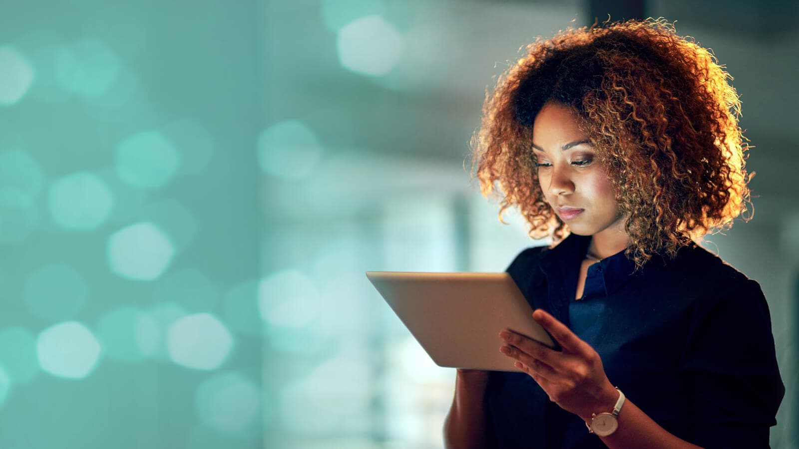 Young businesswoman using a digital tablet during a late night at work