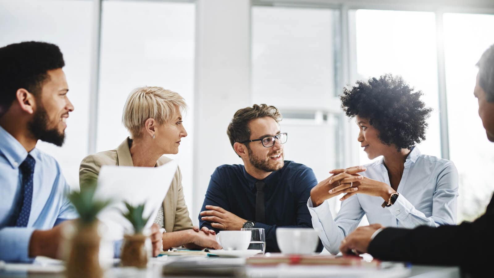 diverse group of businesspeople sitting together and having a meeting