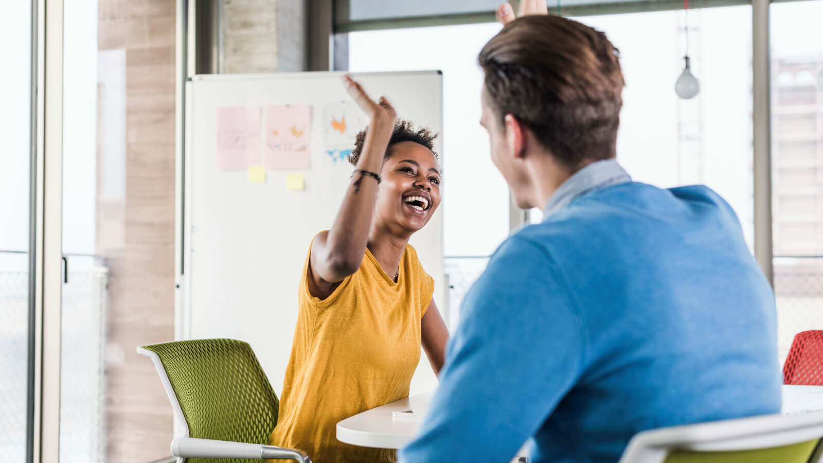 colleagues high 5 in office 