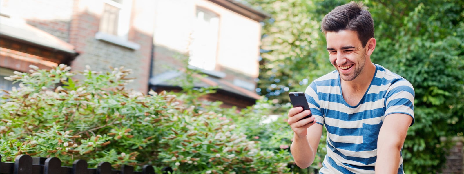 Boy smiling looking at phone