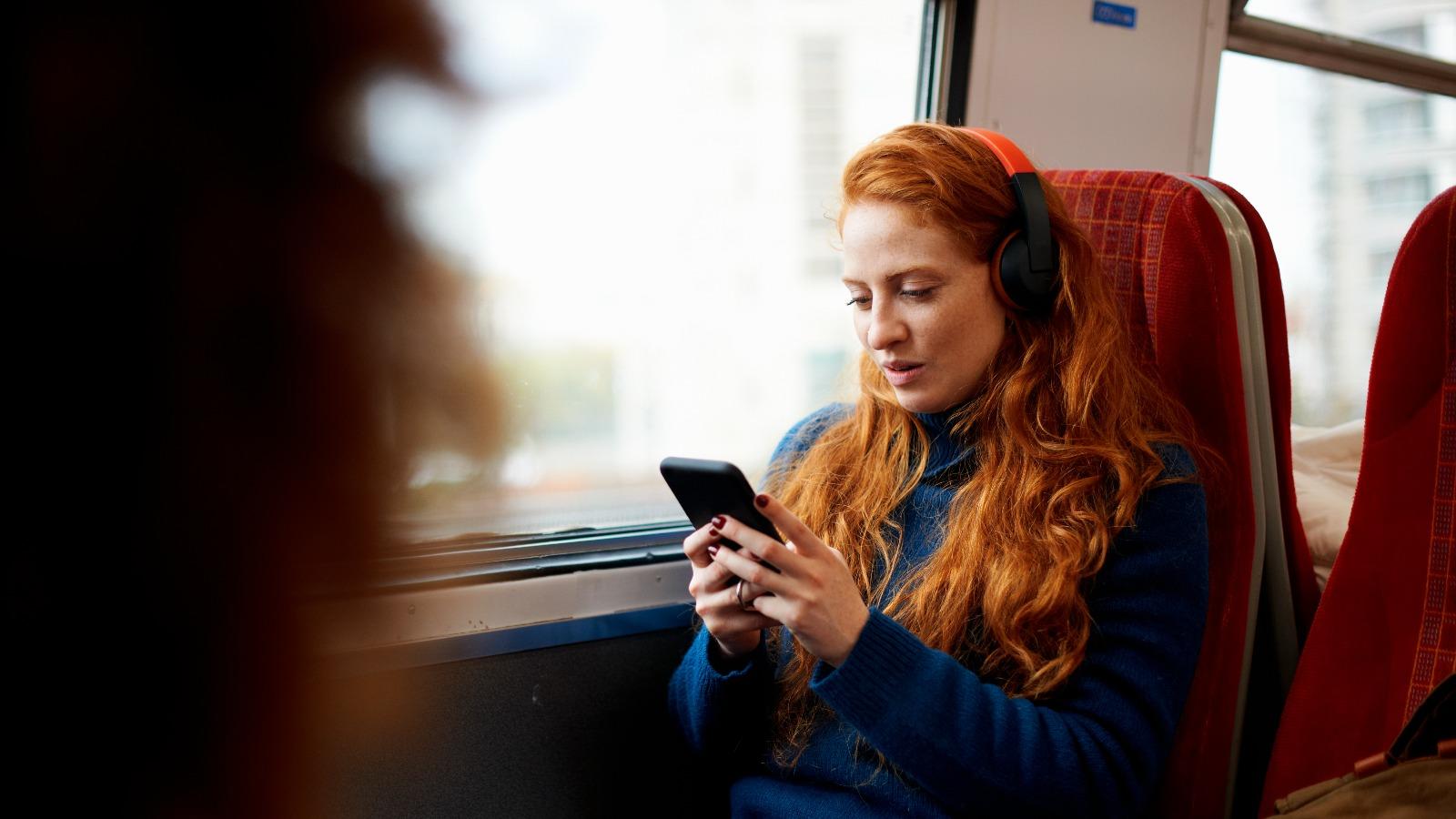 Woman using phone on the train